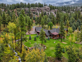 Nestled amidst a lush forest and rolling hills, this stunning property offers a serene mountain retreat.