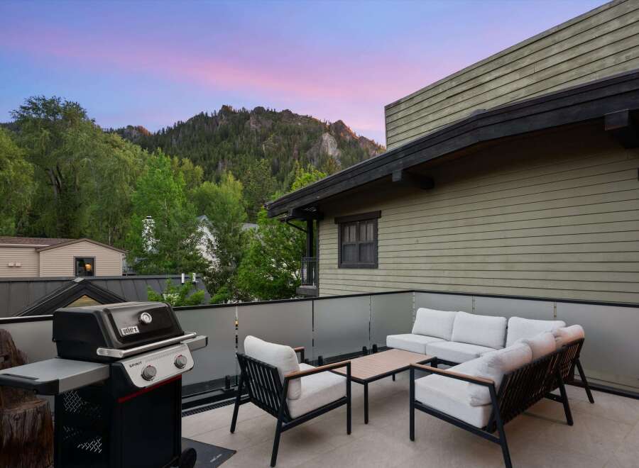 Enjoy breathtaking mountain views from this stunning rooftop patio, perfect for entertaining or relaxing.
