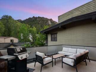 Enjoy breathtaking mountain views from this stunning rooftop patio, perfect for entertaining or relaxing.