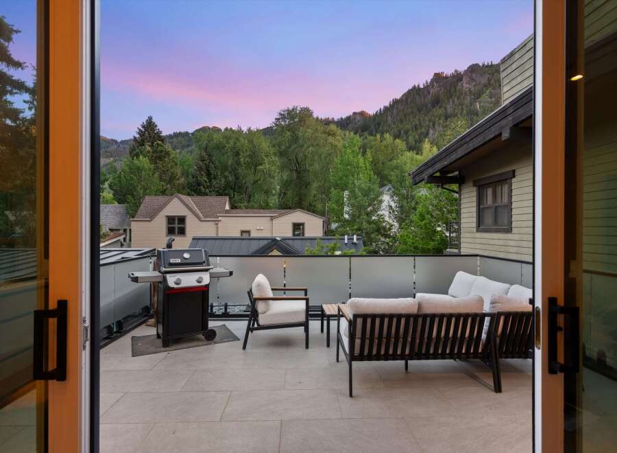 Enjoy breathtaking mountain views from this stunning rooftop patio, perfect for entertaining or relaxing.