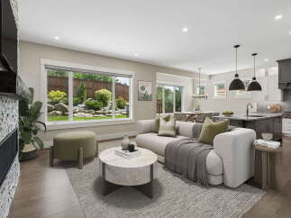 Experience modern living in this open-concept home featuring a spacious living area with a stone fireplace and large windows overlooking a lush backyard.