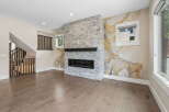 Experience modern living in this stunning great room, featuring a striking stacked stone fireplace as the focal point.