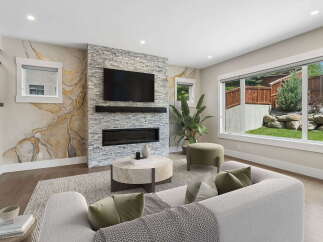 Experience modern living in this stunning living room, featuring a striking stone fireplace and a large television perfect for entertainment.