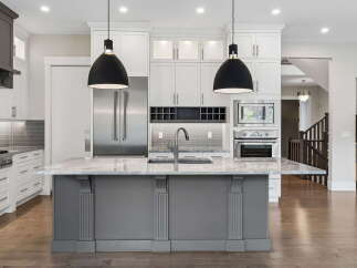 Experience luxury in this stunning modern kitchen, featuring a spacious island with a sleek faucet and ample counter space.