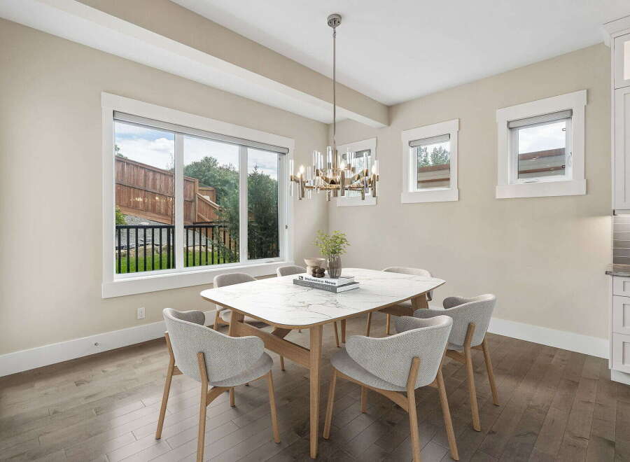 Experience elegant dining in this beautifully appointed space, featuring a stunning marble-top table surrounded by comfortable, modern chairs.