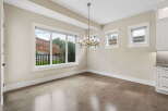Experience modern living in this elegant dining area, featuring a stunning chandelier that illuminates the space.
