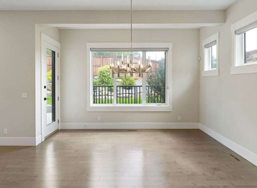 Step into this bright and airy dining room, featuring a stunning modern chandelier that illuminates the space.