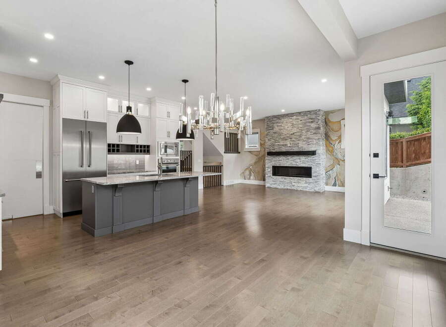 Experience modern living in this open-concept home featuring a gourmet kitchen with a large island and stainless steel appliances.