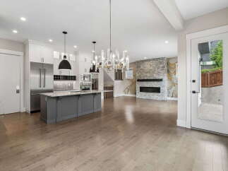 Experience modern living in this open-concept home featuring a gourmet kitchen with a large island and stainless steel appliances.