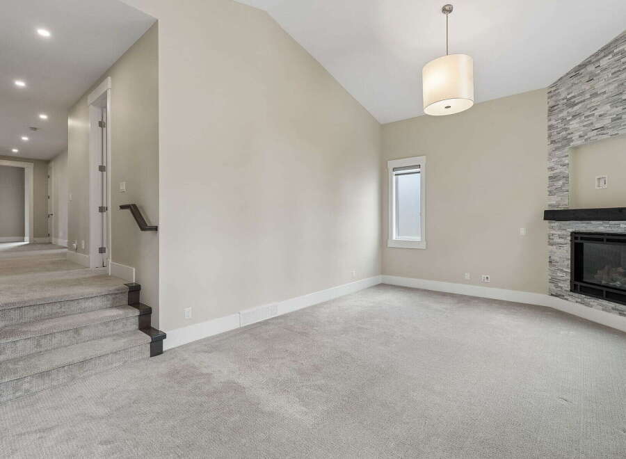 Step into this inviting living space featuring a stunning stone-clad fireplace, perfect for cozy evenings.