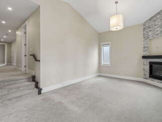 Step into this inviting living space featuring a stunning stone-clad fireplace, perfect for cozy evenings.