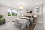 Experience luxurious comfort in this beautifully appointed bedroom, featuring a spacious king-sized bed with plush bedding and decorative pillows.