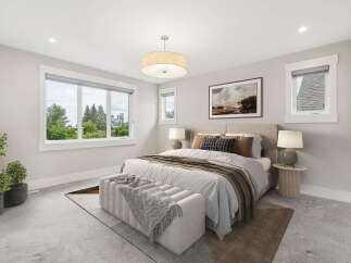 Experience luxurious comfort in this beautifully appointed bedroom, featuring a spacious king-sized bed with plush bedding and decorative pillows.