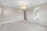 Step into this spacious bedroom featuring a neutral color palette and plush carpeting for ultimate comfort.