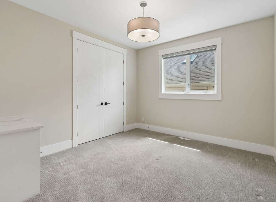 This bright and airy bedroom features a large double door closet, perfect for ample storage.