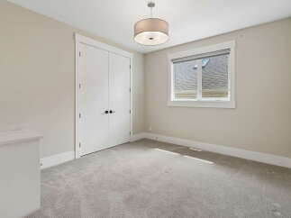 This bright and airy bedroom features a large double door closet, perfect for ample storage.
