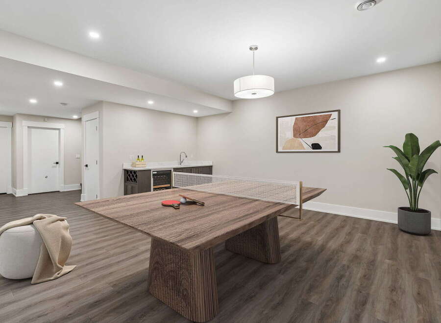 This modern basement features a versatile space perfect for entertainment and relaxation.
