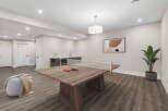 This modern basement features a versatile space perfect for entertainment and relaxation.