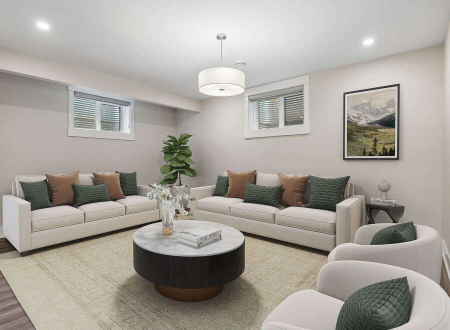 This inviting living room features a spacious layout with two comfortable sofas and two accent chairs, perfect for entertaining guests.
