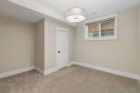 This unfurnished room features neutral-toned walls and carpeting, creating a versatile canvas for any decor style.