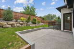Step outside to a beautifully landscaped backyard featuring a spacious concrete patio, perfect for entertaining.