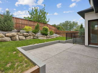 Step outside to a beautifully landscaped backyard featuring a spacious concrete patio, perfect for entertaining.