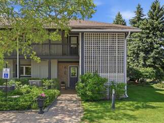 Discover this charming property featuring a welcoming brick entrance and a decorative white lattice screen.