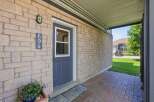 Welcome to this charming property featuring a welcoming front entrance with a stylish dark blue door and a decorative light fixture.