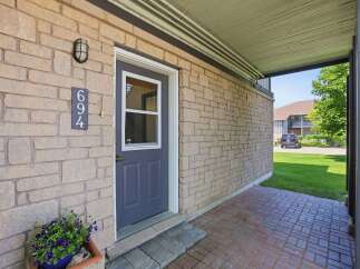 Welcome to this charming property featuring a welcoming front entrance with a stylish dark blue door and a decorative light fixture.