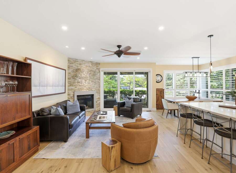 This open-concept living space seamlessly blends a cozy living area with a modern kitchen and dining space.