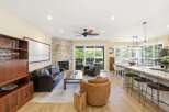 This open-concept living space seamlessly blends a cozy living area with a modern kitchen and dining space.