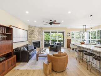 This open-concept living space seamlessly blends a cozy living area with a modern kitchen and dining space.