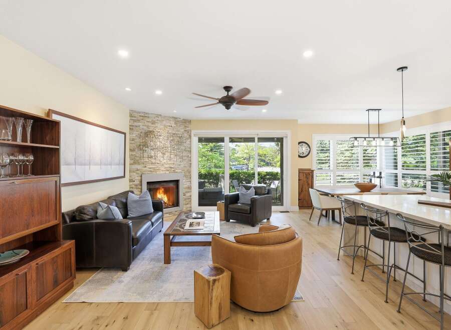 This open-concept living space seamlessly blends a cozy living area with a modern kitchen and dining space.