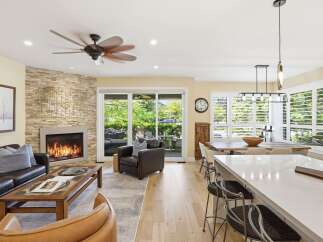 Experience luxurious open-concept living with a stunning stone fireplace as the centerpiece of this inviting living area.