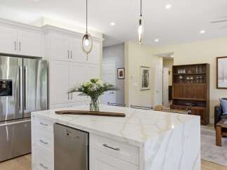Experience modern living in this stunning kitchen, featuring sleek white cabinetry and a luxurious marble island perfect for entertaining.