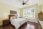 Experience comfort and style in this beautifully appointed bedroom, featuring a plush queen-size bed adorned with textured pillows and a crisp white quilt.