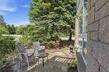 Enjoy your morning coffee on this charming stone patio, complete with comfortable wicker seating and a glass-top table.