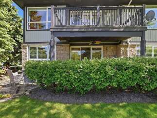 Enjoy outdoor living with a spacious balcony and a lower patio area, perfect for entertaining or relaxing.