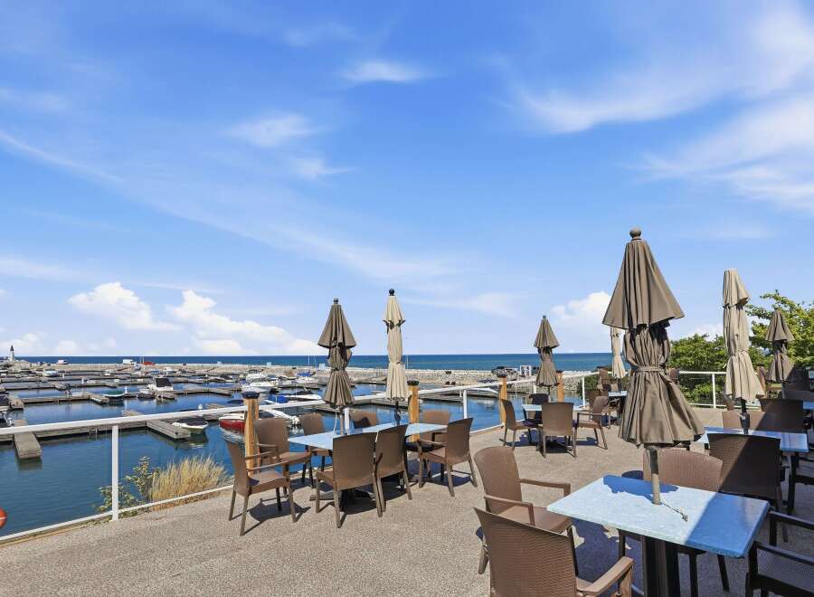 Enjoy breathtaking waterfront views from this stunning property's outdoor dining area.