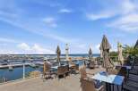 Enjoy breathtaking waterfront views from this stunning property's outdoor dining area.