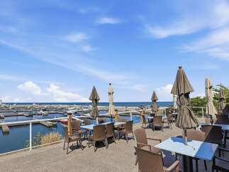 Enjoy breathtaking waterfront views from this stunning property's outdoor dining area.