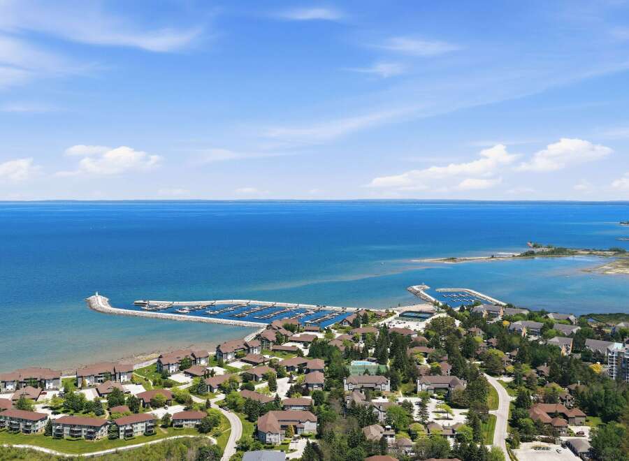 Experience waterfront living at its finest with this stunning aerial view of a coastal community.