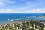 Experience waterfront living at its finest with this stunning aerial view of a coastal community.