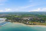 Experience waterfront living at its finest with this stunning aerial view of a modern marina and upscale residential community.
