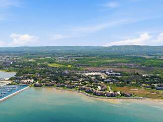 Experience waterfront living at its finest with this stunning aerial view of a modern marina and upscale residential community.