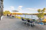 Enjoy breathtaking lake views from this stunning patio, perfect for al fresco dining or relaxing with a drink.