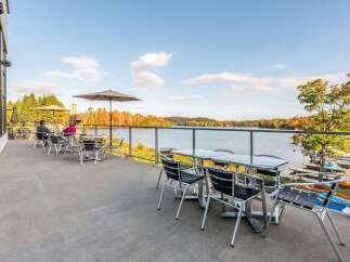 Enjoy breathtaking lake views from this stunning patio, perfect for al fresco dining or relaxing with a drink.