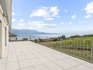Enjoy breathtaking panoramic views of the lake and mountains from this expansive terrace.