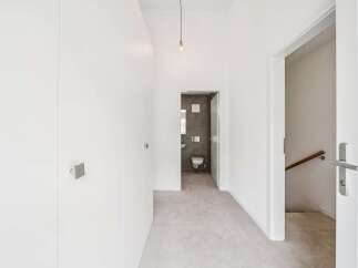 Discover modern living in this bright hallway featuring sleek white walls and minimalist design.