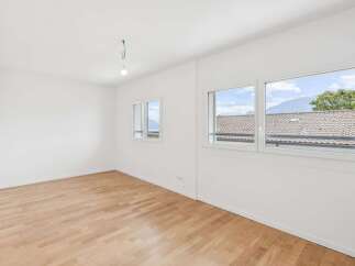 Discover this bright and airy room featuring a beautiful hardwood floor and large windows that offer stunning views of the surrounding landscape.